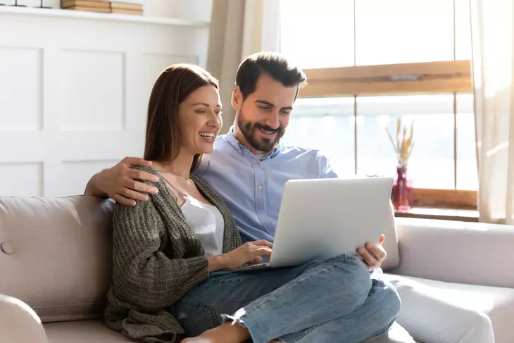 couple at home browsing internet on computer