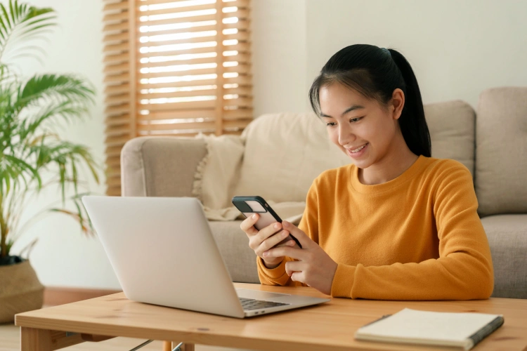 Woman using phone while applying for a loan online