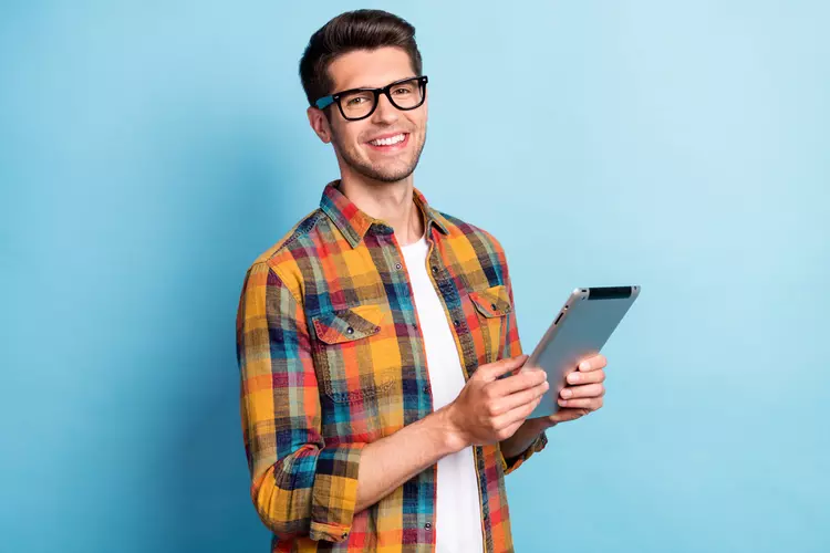 Young man using a tablet to apply for payday loans online