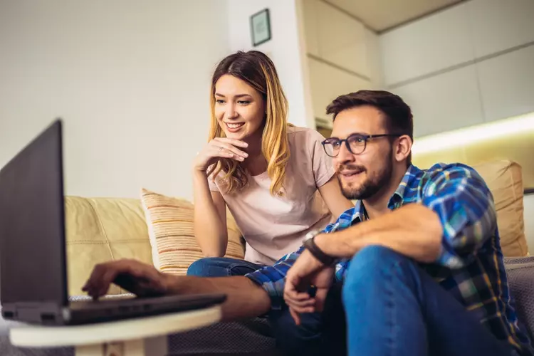 Couple reviewing payday loan terms on a laptop at home