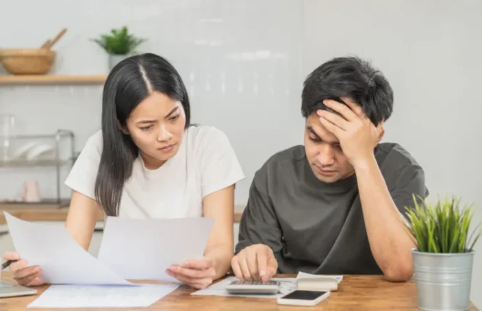 Couple reviewing loan calculator figures