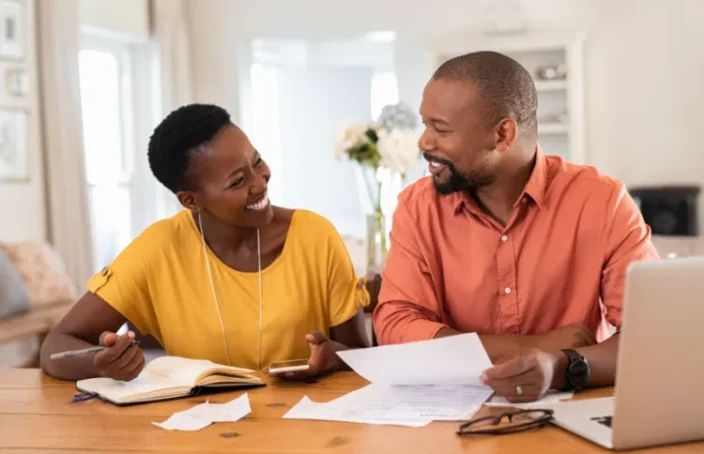 Happy couple reviewing household budget