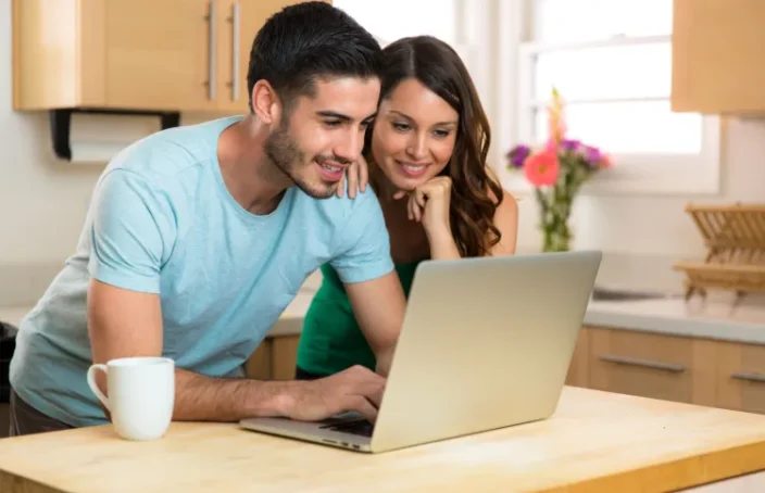 Smiling couple browsing loan options