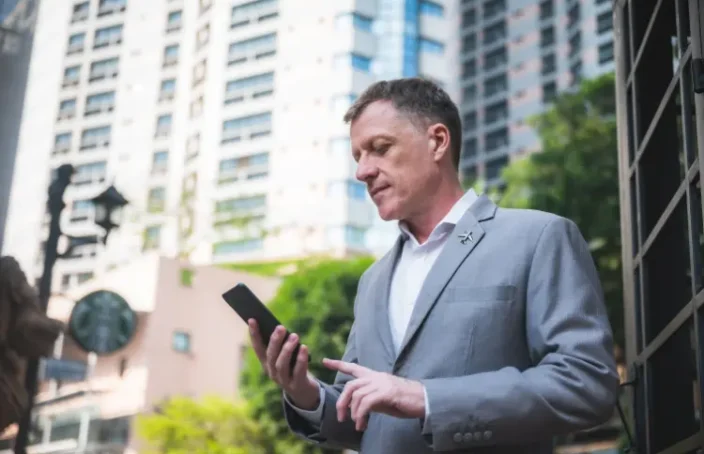 Man checking loan rules on his phone