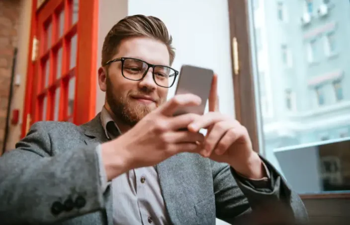 Young professional checking loan details on a smartphone