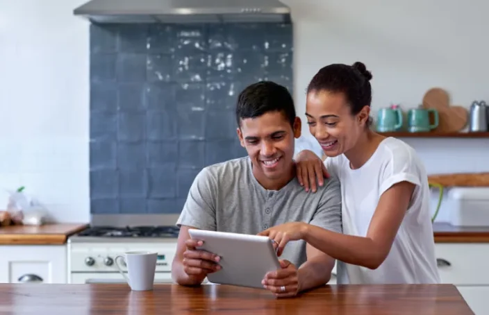 Couple reviewing loan options on a tablet at home