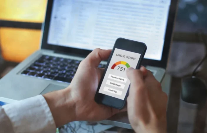 Person viewing a credit score on a smartphone
